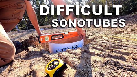 Placing 9 Sonotube Concrete Forms in Very Sloppy Holes [and Bedrock].